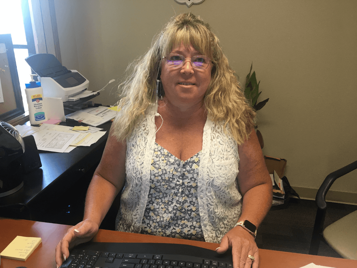 SkillSource client Renee at her desk doing accounting work.