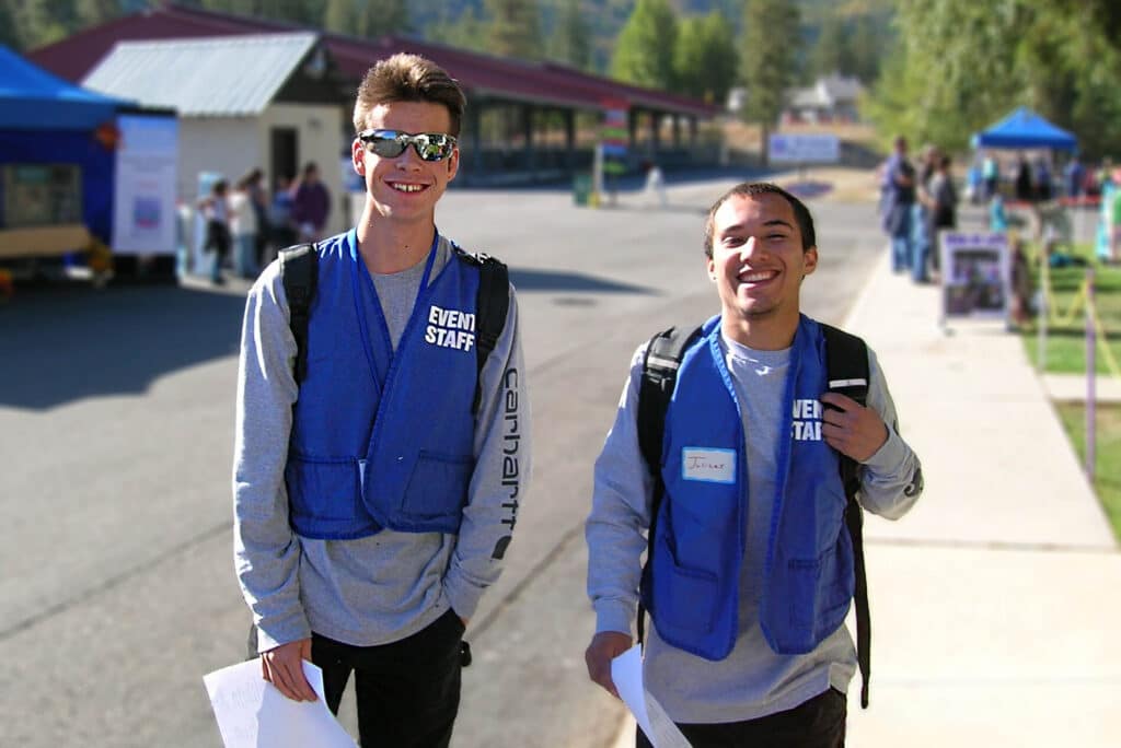 Two young men volunteering at a  SkillSource community event.