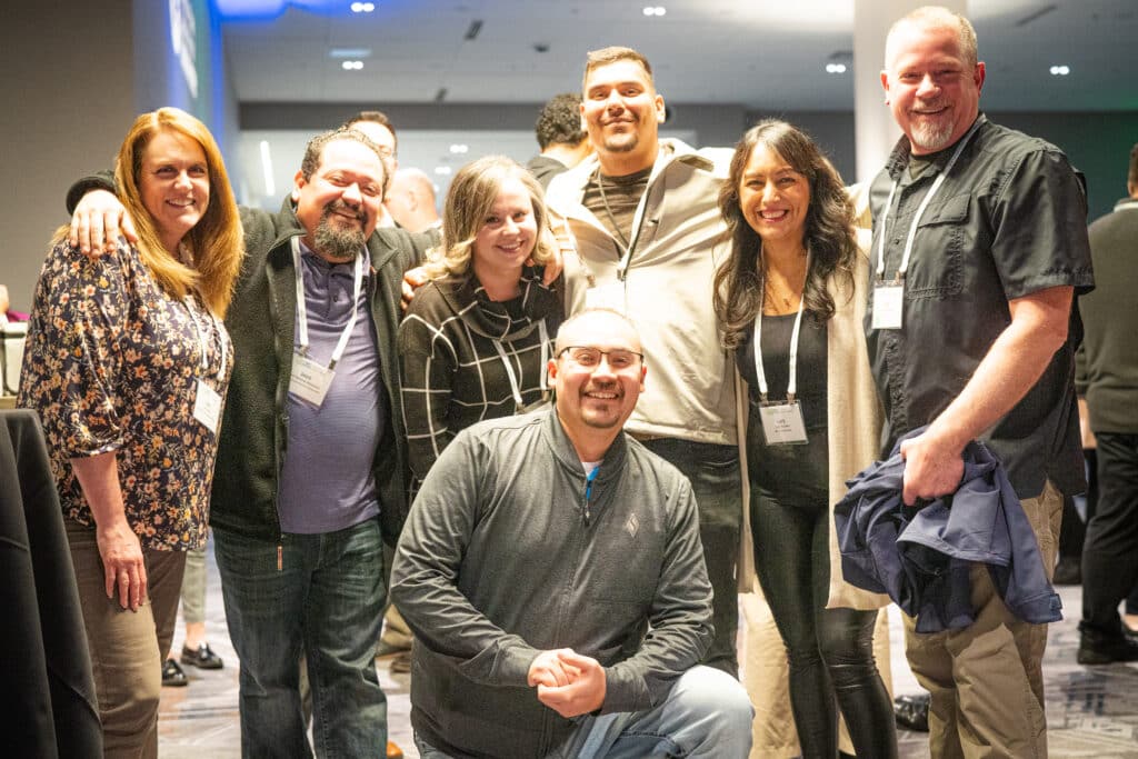 A smiling group of seven staff members.