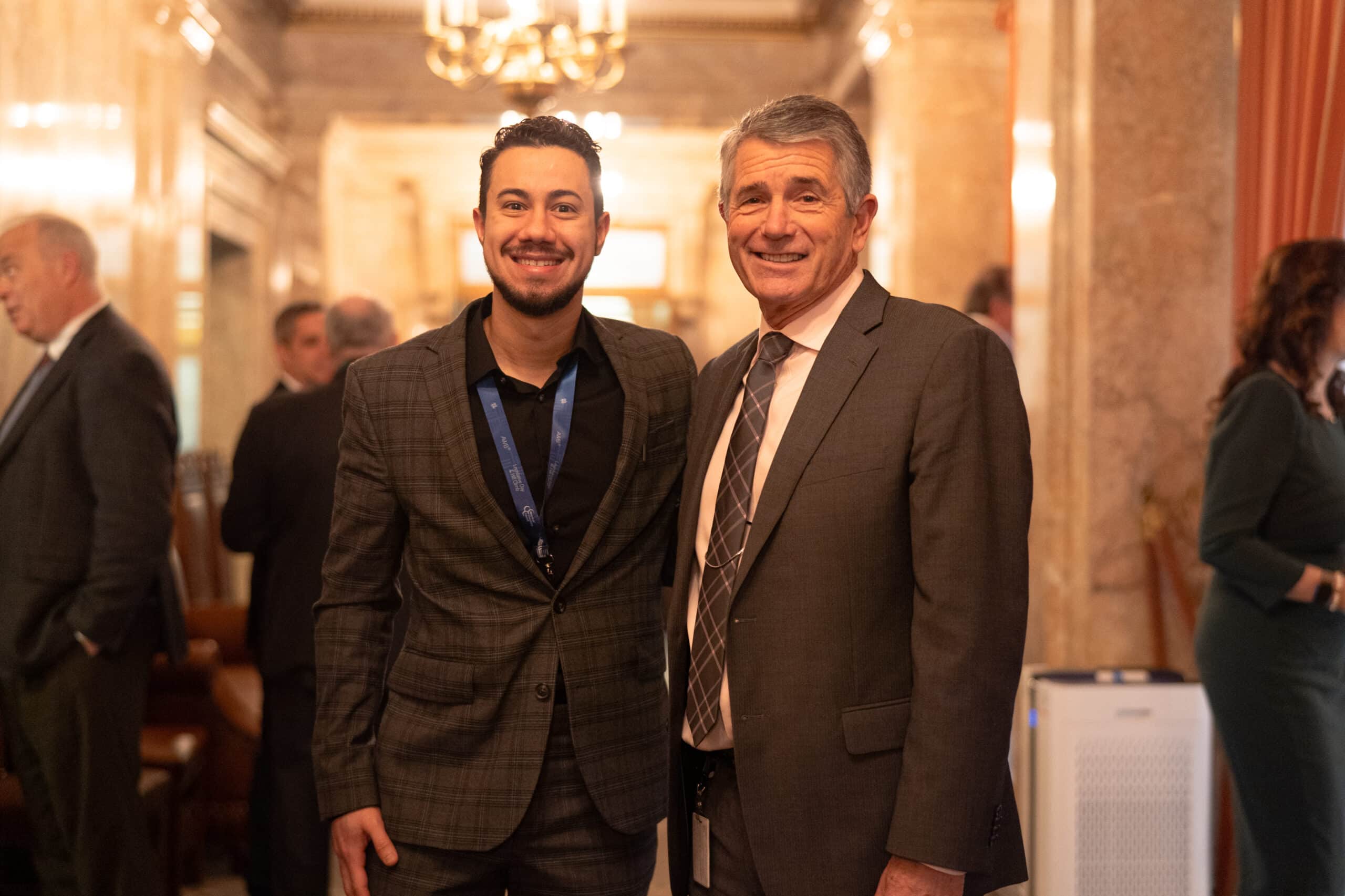 SkillSource participant Domenico Tadeschi stands in the hallway of the Washington State Capitol with Representative Keith Goehner.