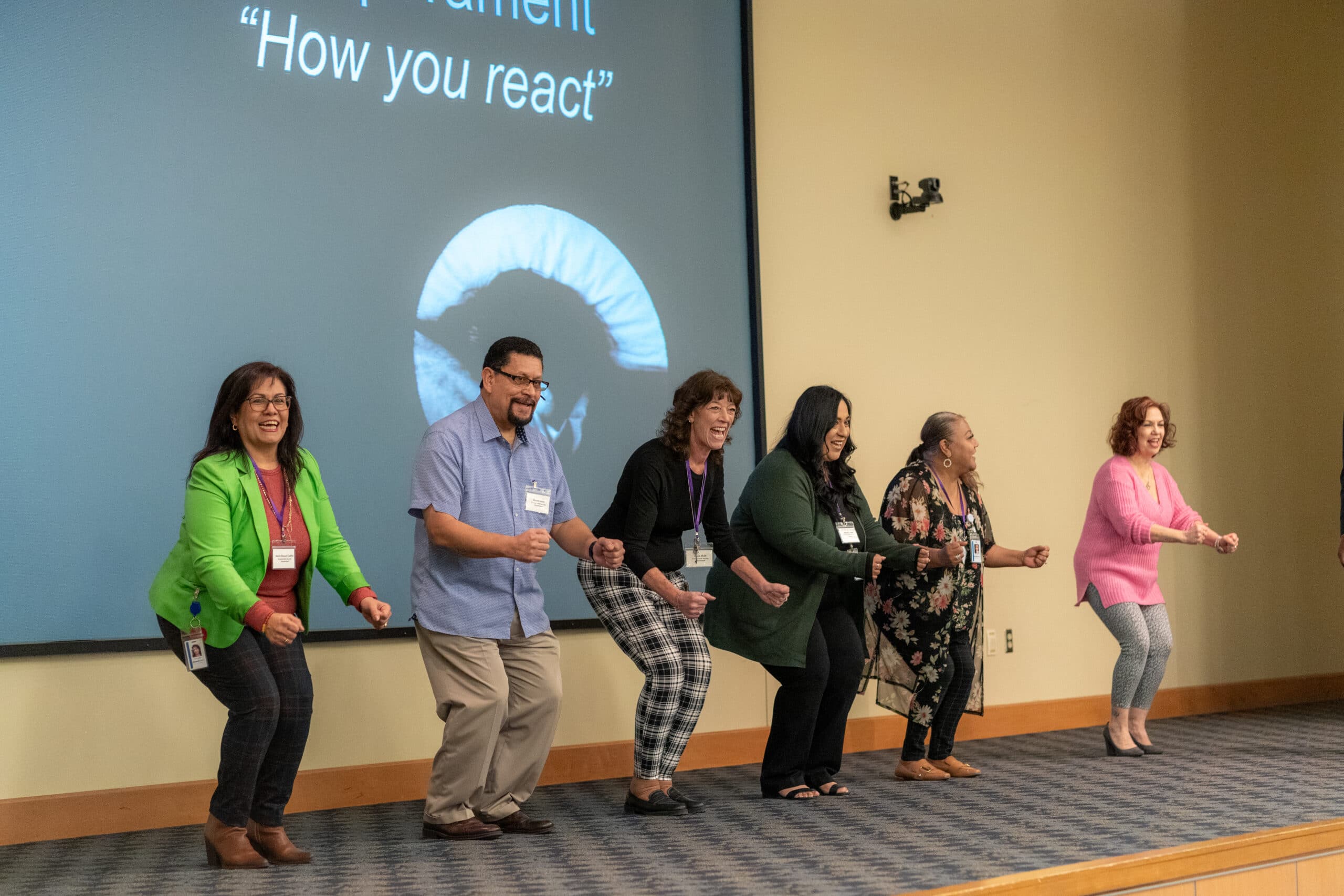 Event attendees participate in a fun exercise on stage.