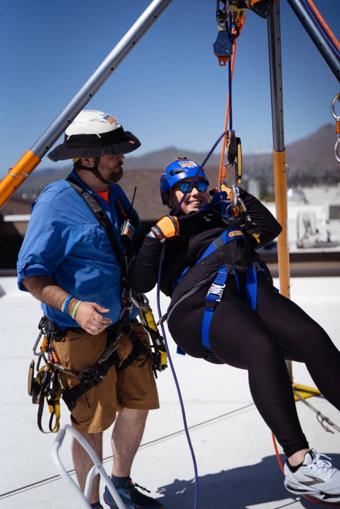 Woman getting ready to Rappel off the Residence Inn Building