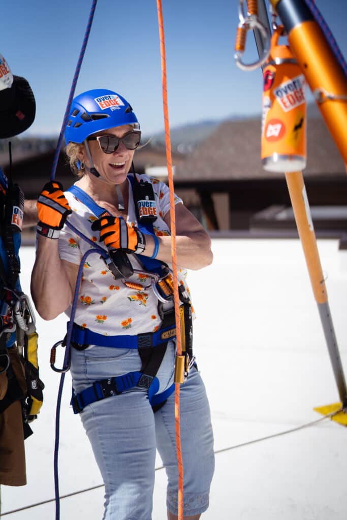 Woman smiling with her rappelling gear on