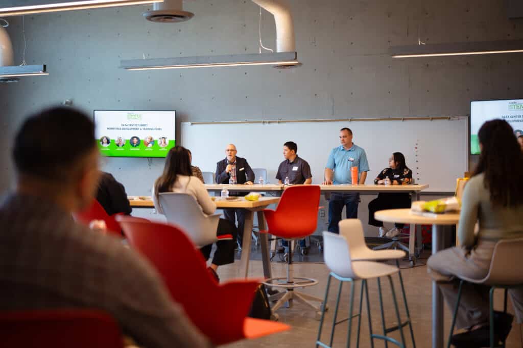 A group of 5 individuals talking to a group of people at Big Bend Community College.