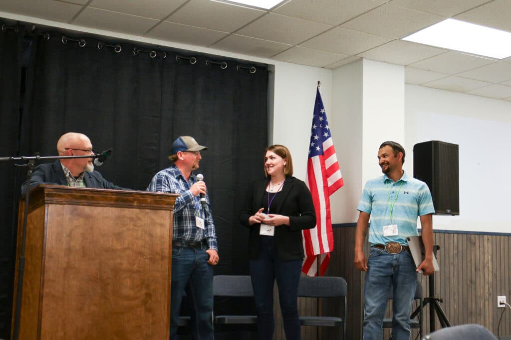 A group of 4 people 3 men and 1 woman doing a presentation