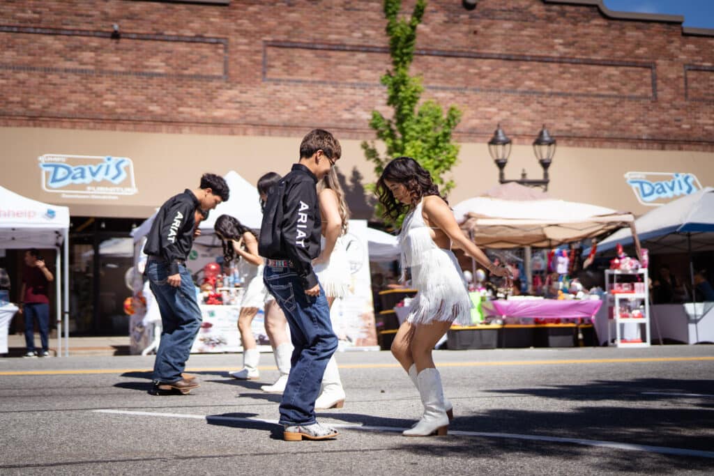A group of teenagers dancing in the street