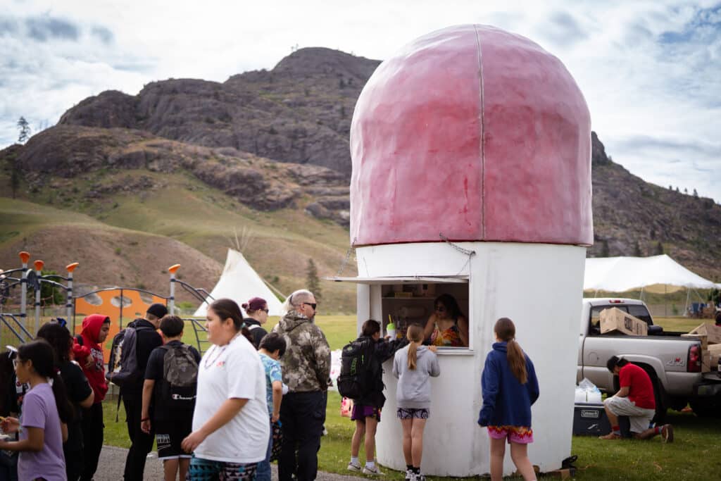 Groups of people in line to get shaved ice